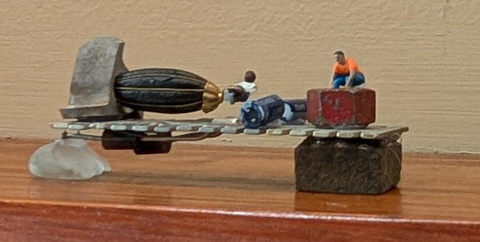 Hands at work building with found objects